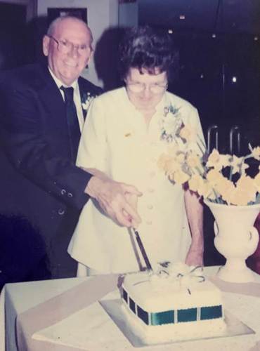 A person and person cutting a cake

AI-generated content may be incorrect.